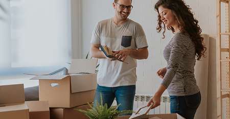 Couple unpacking boxes in new home Couple unpacking boxes in new home