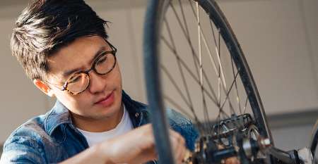 Man fixing bicycle wheel Man fixing bicycle wheel