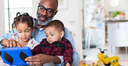 Man holding two young children