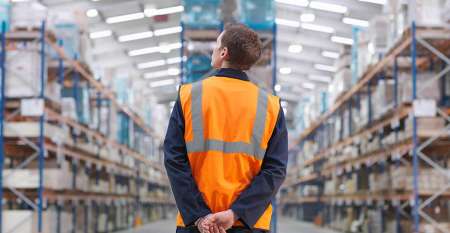 Man looking at warehouse storage shelves