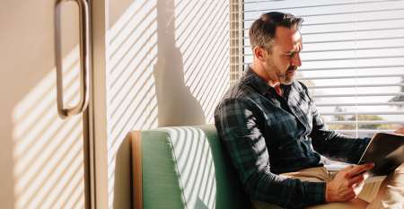 Man looking serious reading notes in reception room