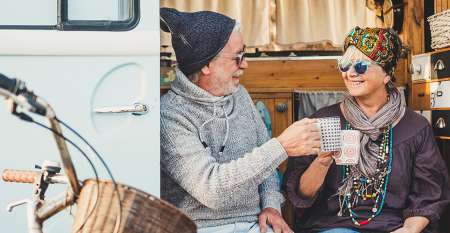 Older couple having teabreak in campervan