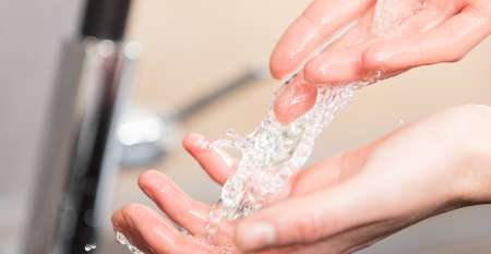 Rinsing hands under tap water Rinsing hands under tap water