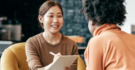 Young lady smiling writing notes Young lady smiling writing notes