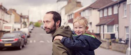 Man carrying baby on his back