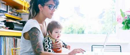 Woman with baby using laptop