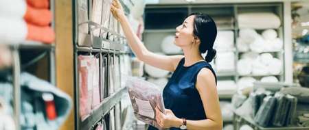 Young woman choosing package in stockroom