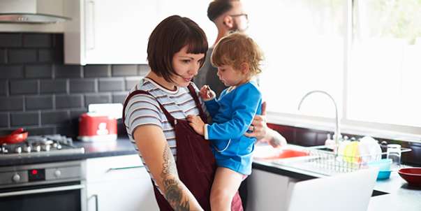Mother holding child in kitchen