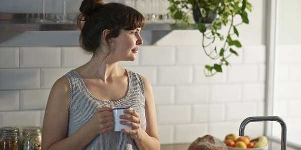 Woman drinking coffee thinking