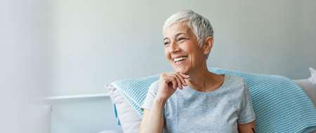 Happy senior woman relaxing on sofa